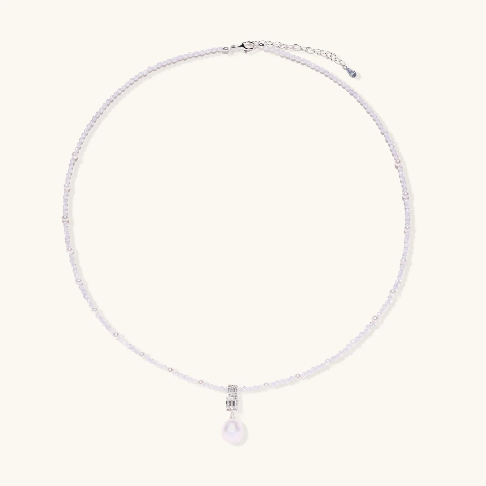Dainty necklace with lavender crystal beads, freshwater pearls, geometric pendant, and large pearl drop on white background.