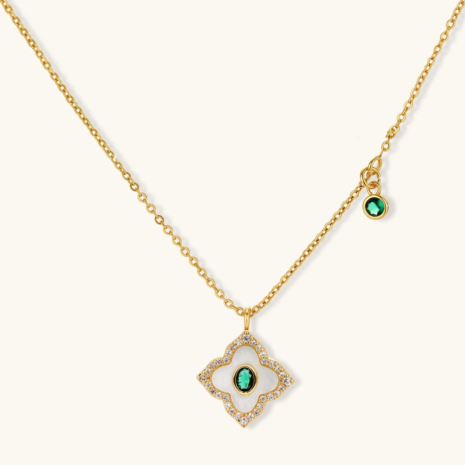 Gold-plated jewelry set with diamond-shaped pendants featuring white centers, green stones, and sparkling zirconia borders