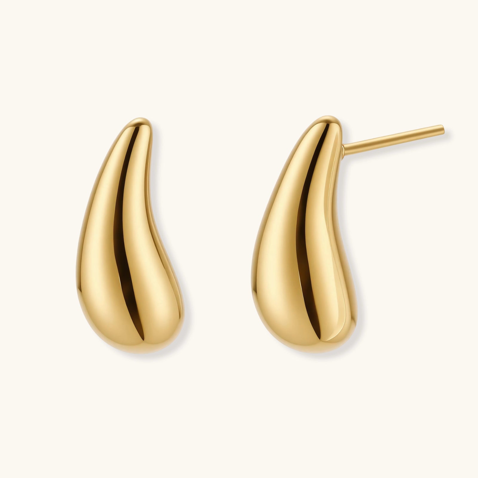 Pair of gold-plated sterling silver teardrop stud earrings with polished finish on white background.