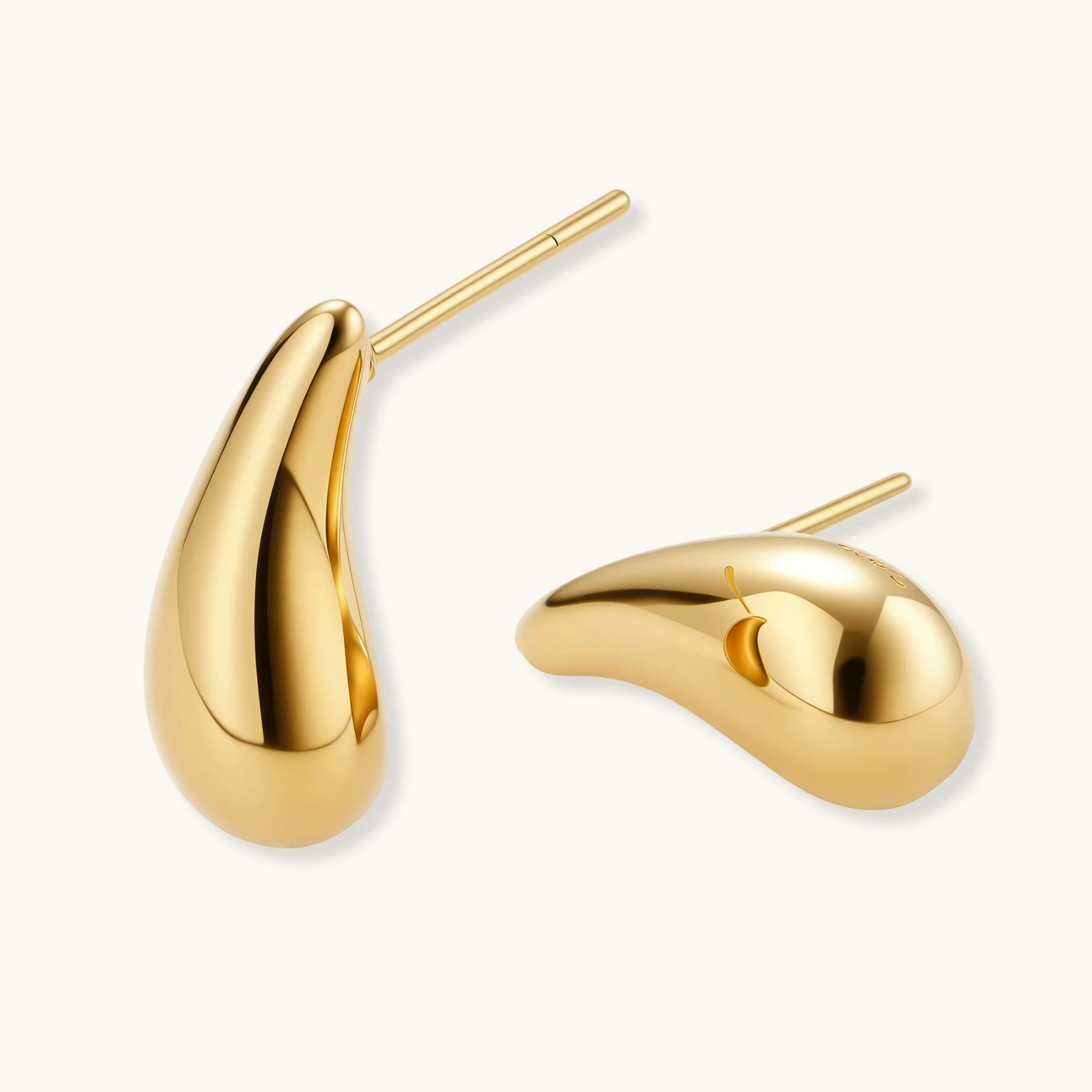 Pair of gold-plated sterling silver teardrop stud earrings with polished finish on white background.