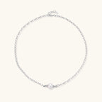 Dainty rhodium-plated silver chain necklace with centered 10mm freshwater pearl and crystal accents on cream background