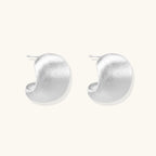 Brushed sterling silver cushion-shaped stud earrings with matte finish on white background