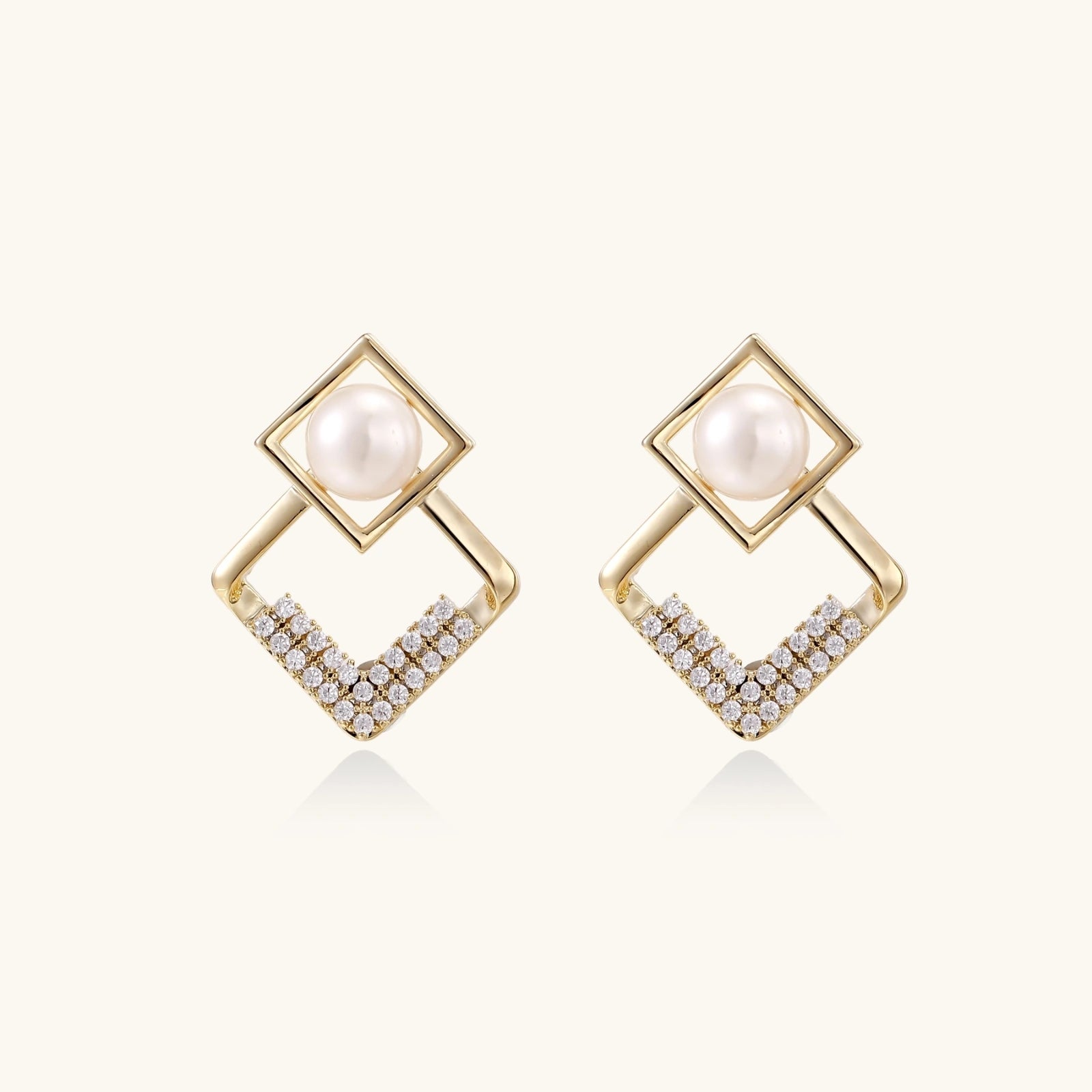 Gold-plated double square frame earrings with freshwater pearl and crystal accents on white background