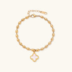 18K gold-plated oval bead chain bracelet with quatrefoil clover charm featuring mother of pearl inlay on cream background