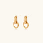 Gold stud earrings with vertical ridged bar connecting to triple interlocking circular rings on white background