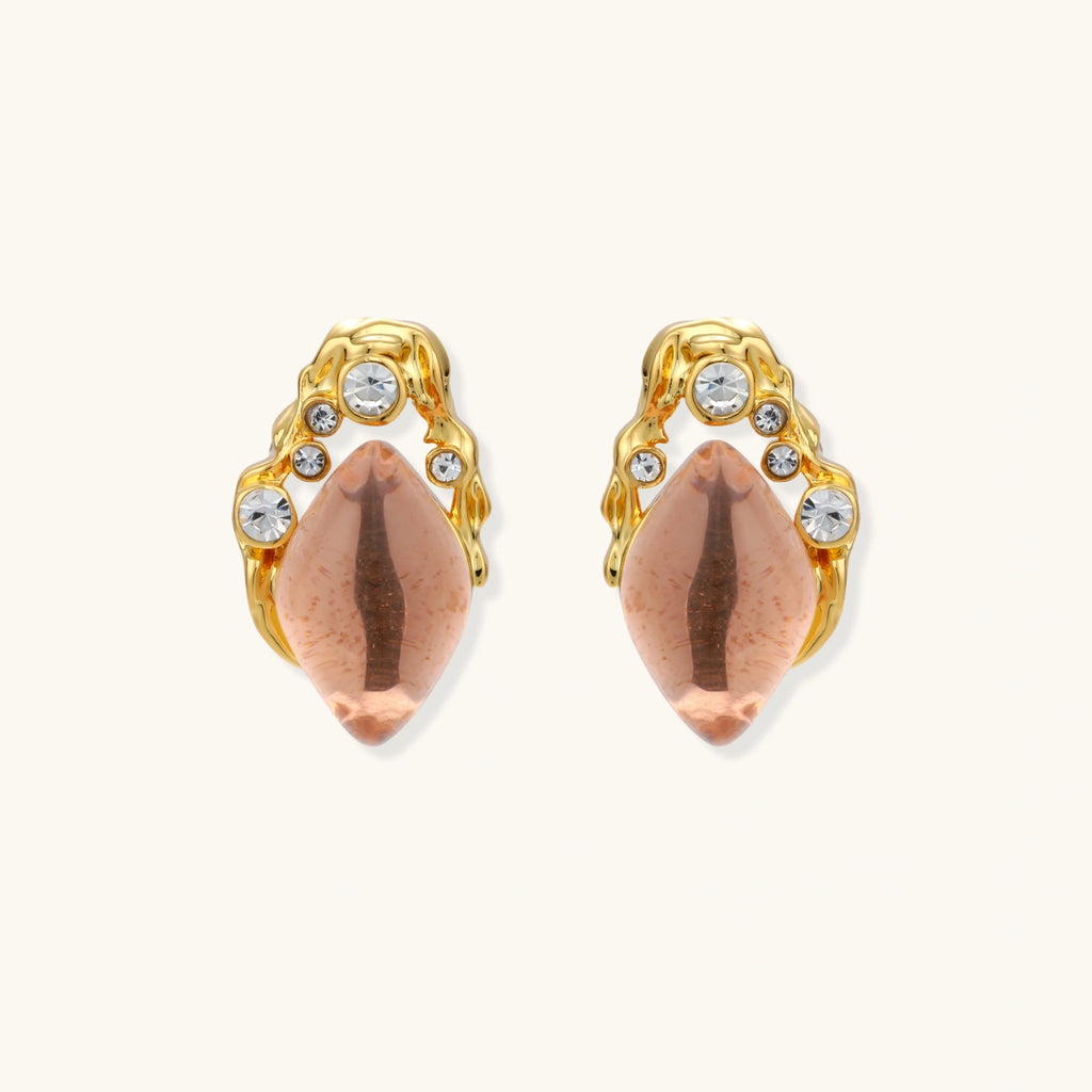 Gold-plated baroque stud earrings with coral-pink liuli stones and cubic zirconia crystals on white background.