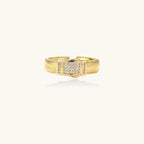 Gold-plated adjustable ring with ribbed band and rectangular pavé cubic zirconia panel on white background.